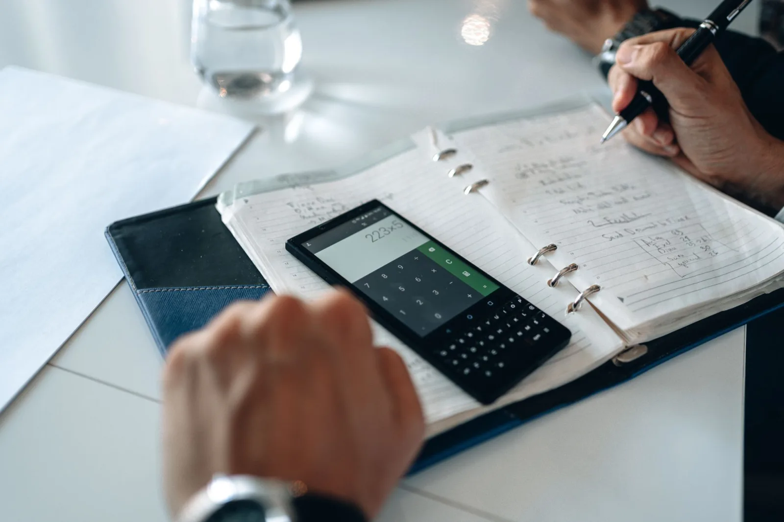 Smartphone und Taschenrechner auf einem Schreibtisch